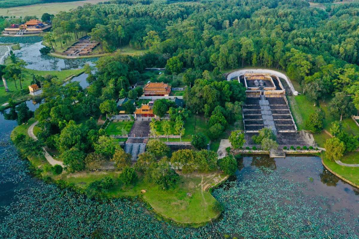 Lotus Wetlands and Tomb Complex at Gia Long Tomb Aerial view of lotus wetlands, lakes, and the historic Gia Long Tomb complex surrounded by dense greenery in Hue.