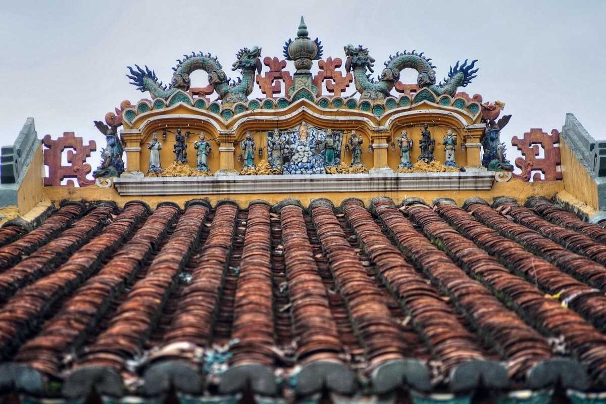 Giac Lam Pagoda Roof Detail with Dragon Sculptures Close-up of ornate roof tiles and dragon sculptures on the traditional roof of Giac Lam Pagoda
