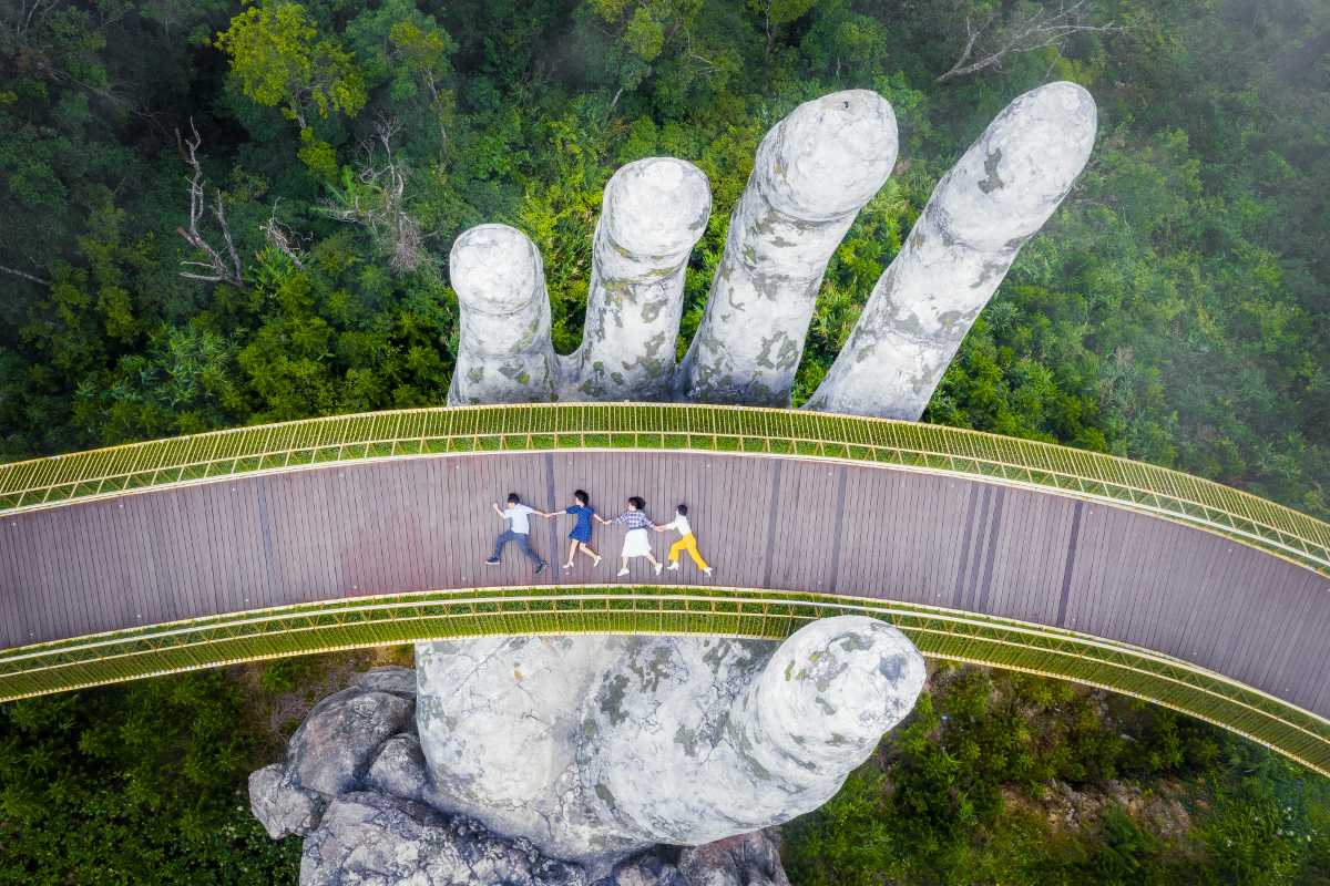 Golden Bridge Da Nang lush garden entrance Entrance to Golden Bridge Da Nang with landscaped gardens, colorful flowers, visitors arriving