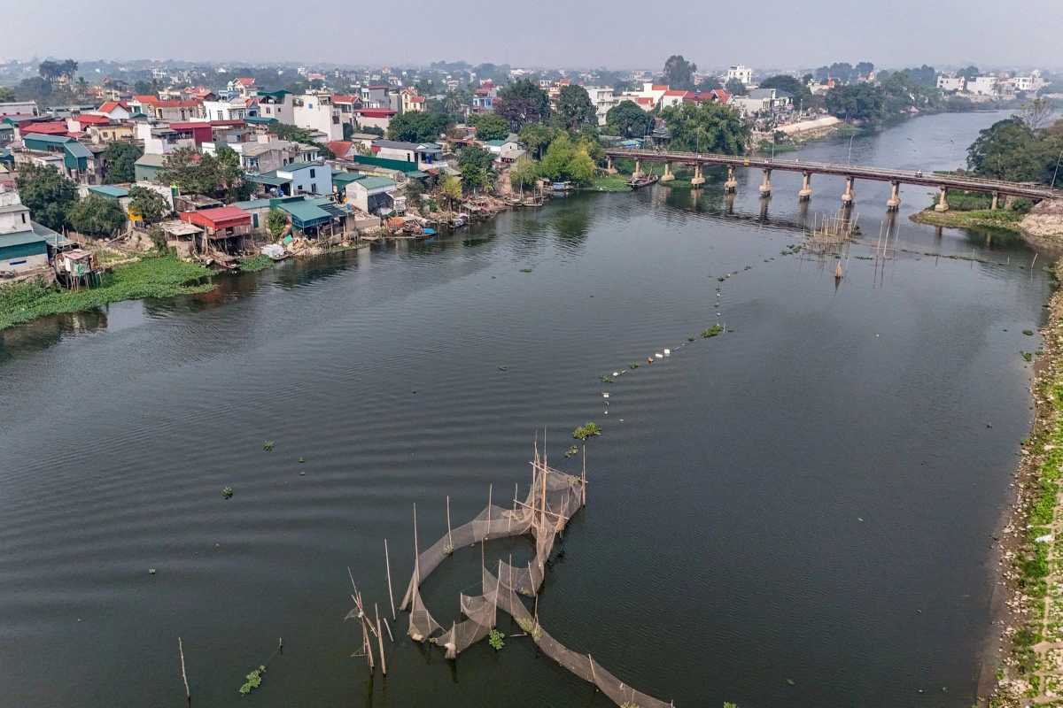 Hanoi Bridge Crossing the Red River Vietnam Bridge spanning the Red River Vietnam with city skyline in the background