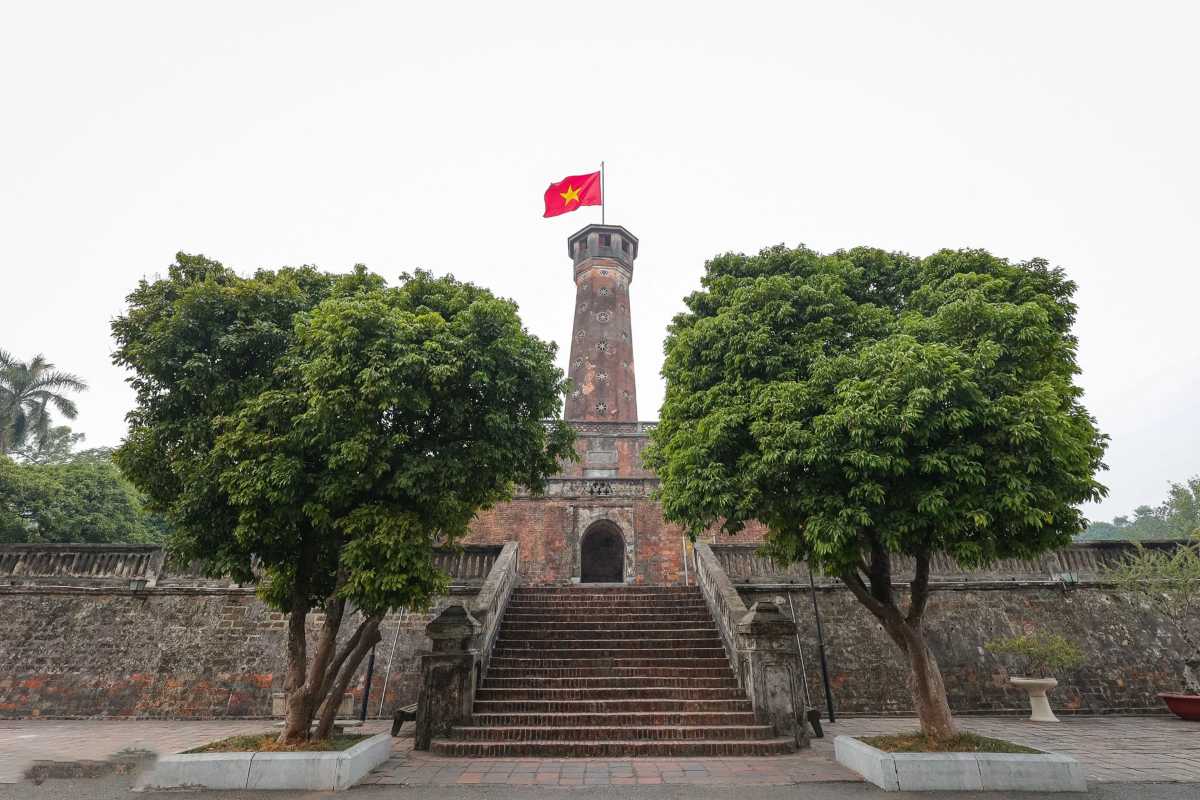 Hanoi Flag Tower with Historic Cannons and Visitors Visitors viewing historic cannons beside Hanoi Flag Tower