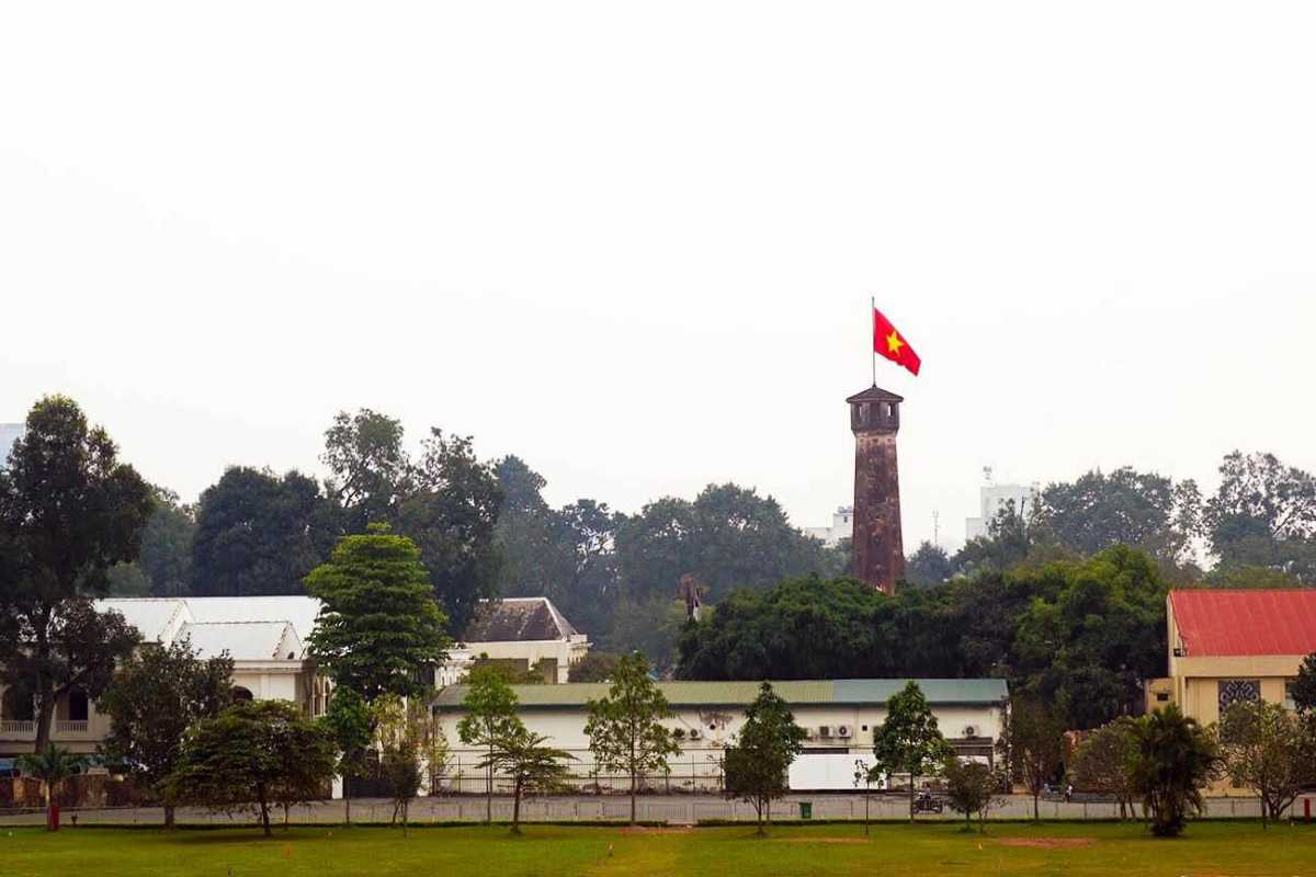 Hanoi Flag Tower from Distance with Garden Hanoi Flag Tower visible behind a decorative garden with dragon sculptures