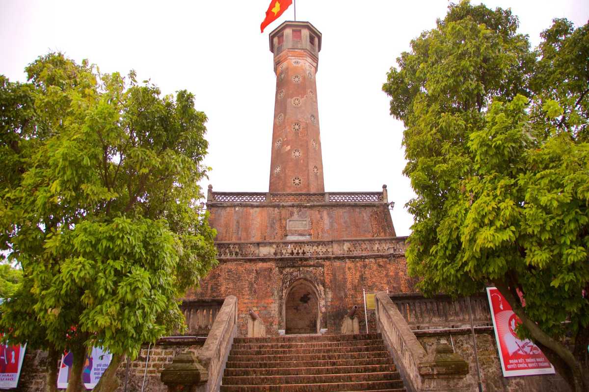 Visitors Taking Photos at Hanoi Flag Tower Tourists taking photos of the ancient Hanoi Flag Tower with Vietnamese flag on top