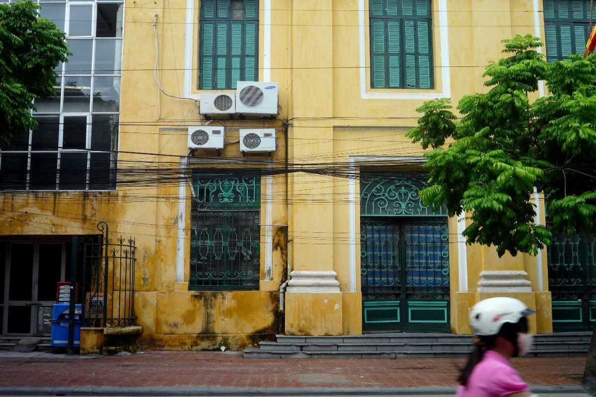 Hanoi French Quarter Classic Yellow Facade Classic yellow colonial building facade with green shutters in Hanoi French Quarter