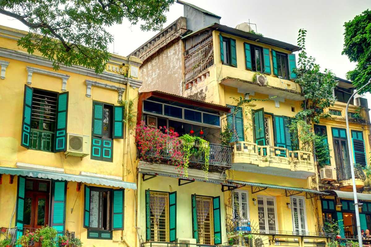 Hanoi French Quarter Colonial Architecture Colonial architecture buildings with yellow facades and green shutters in Hanoi French Quarter