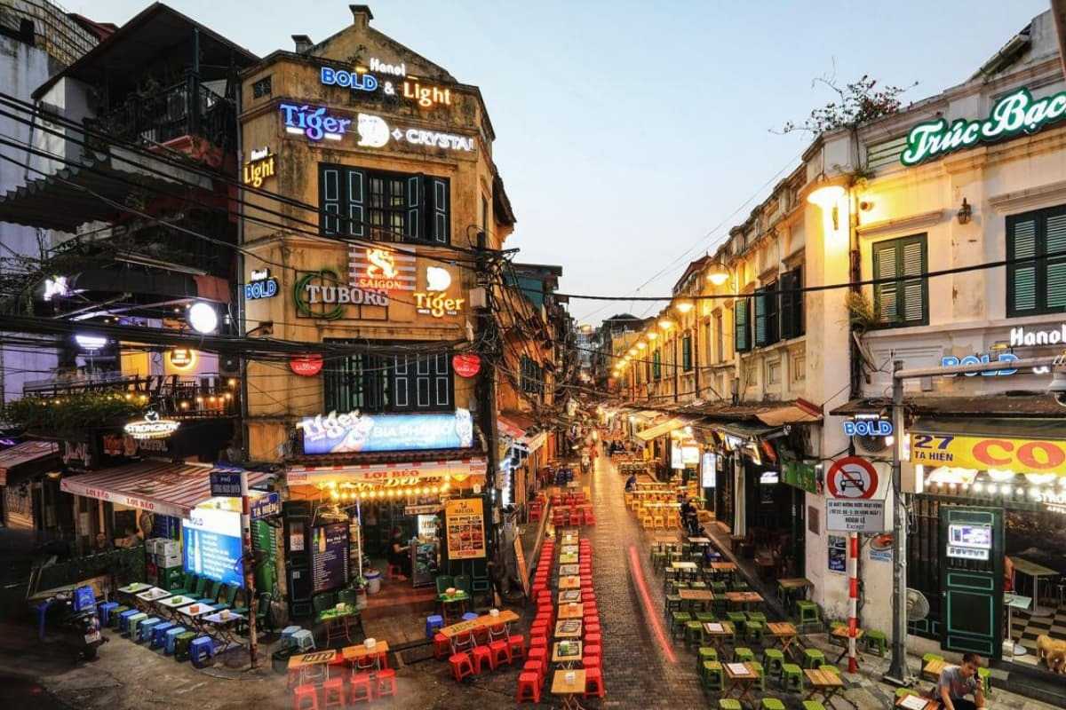Hanoi French Quarter Evening Street Market Evening street market scene with food stalls and neon signs in Hanoi French Quarter