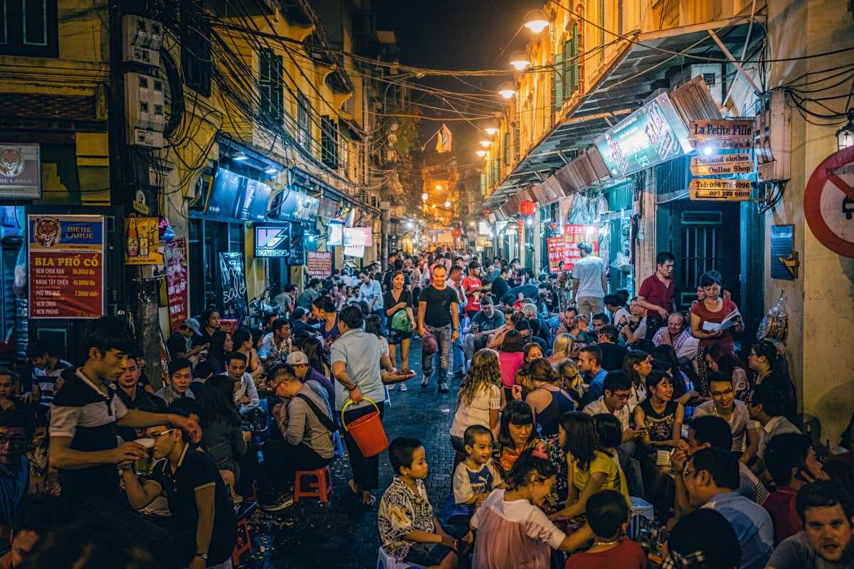 Hanoi Old Quarter night street food scene Crowded night street food scene with locals and tourists enjoying food in the Hanoi Old Quarter