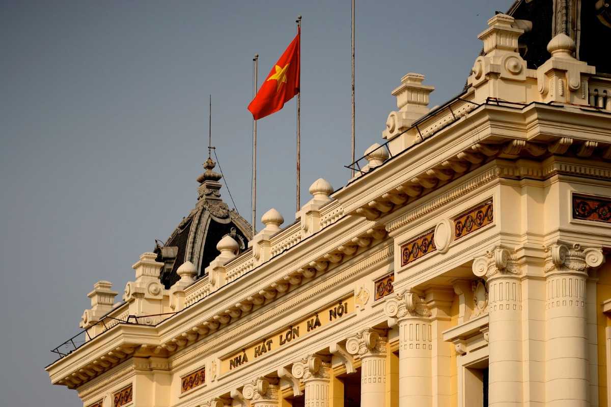 Hanoi Opera House Daytime Front View Hanoi Opera House bright facade with clear sky and busy street traffic