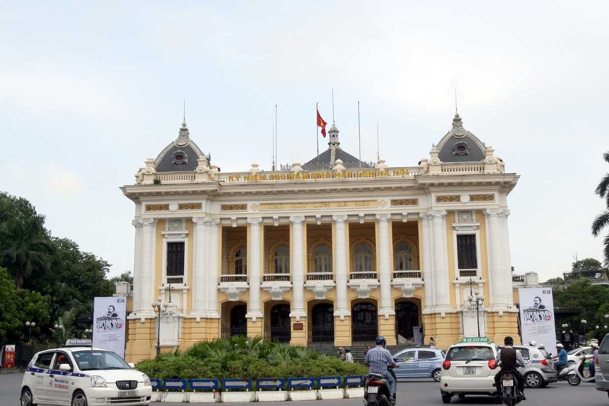 Hanoi Opera House Main Entrance with Visitors Main entrance of Hanoi Opera House bustling with visitors and motorbikes