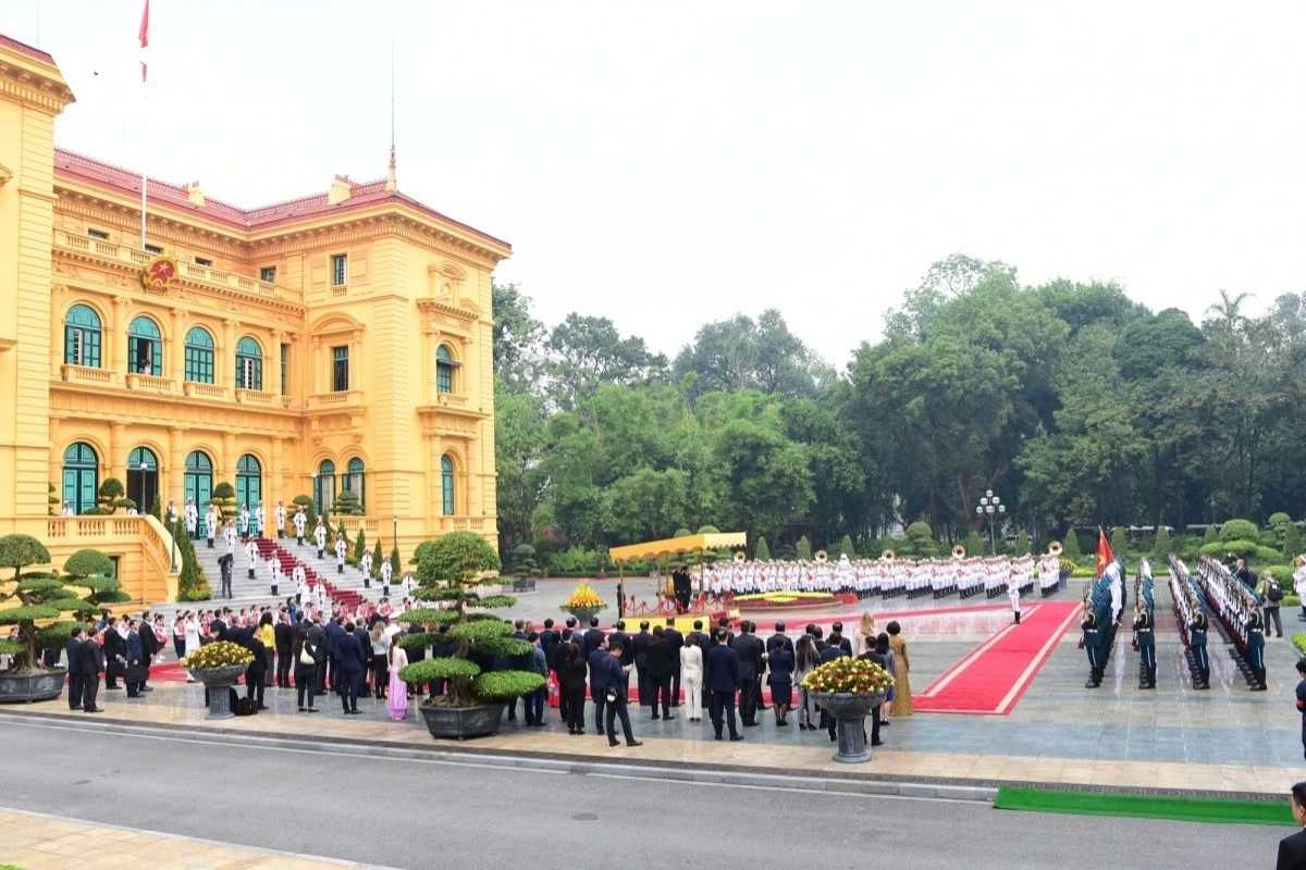 Hanoi Presidential Palace Front View with Ceremony Front view of the Hanoi Presidential Palace showcasing the grand building during an official ceremony