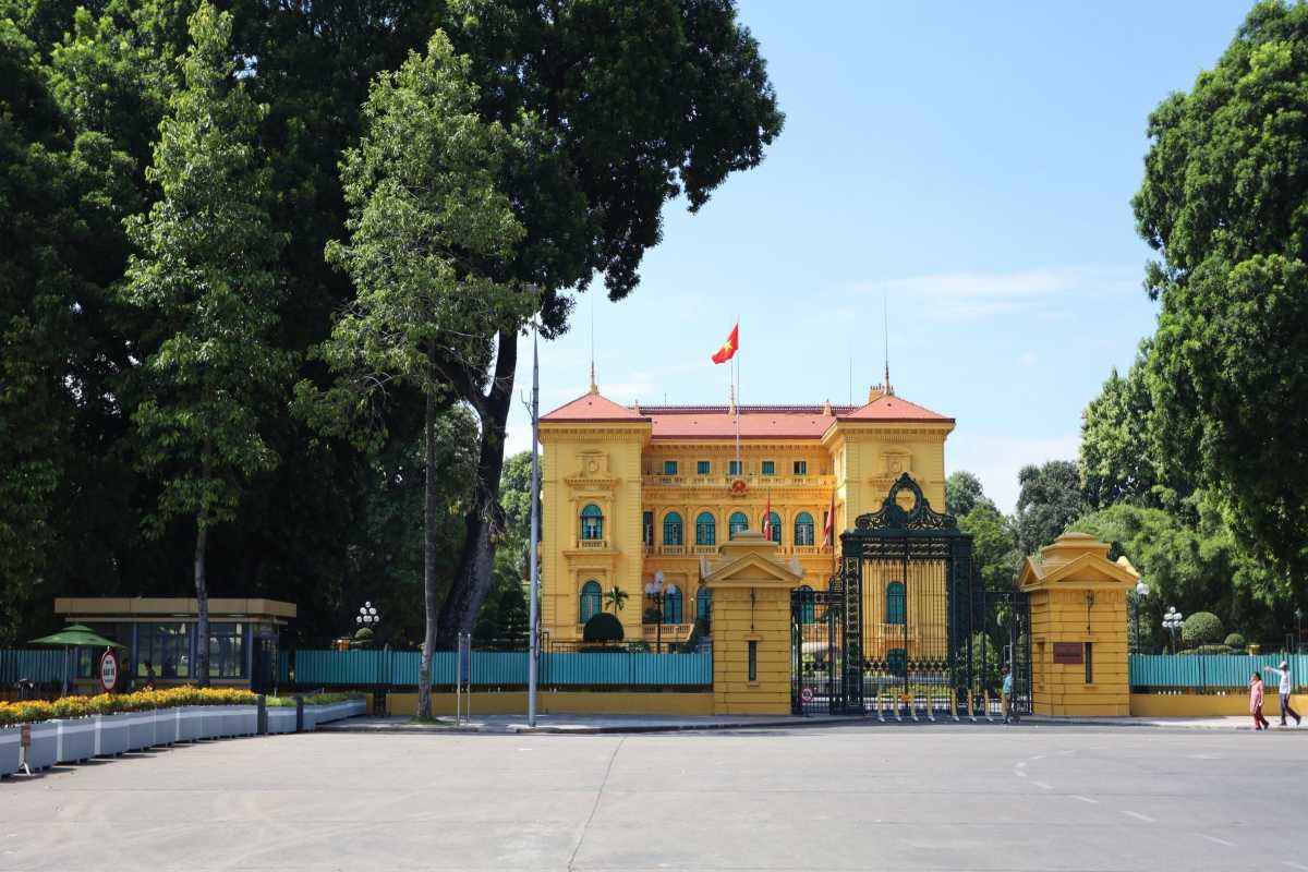 Hanoi Presidential Palace Exterior with Trees The Hanoi Presidential Palace exterior framed by trees and gardens on a sunny day