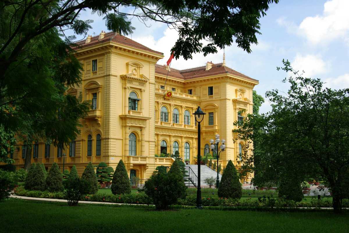 Hanoi Presidential Palace Gardens and Fountain Fountain and gardens in front of the Hanoi Presidential Palace reflecting the yellow building