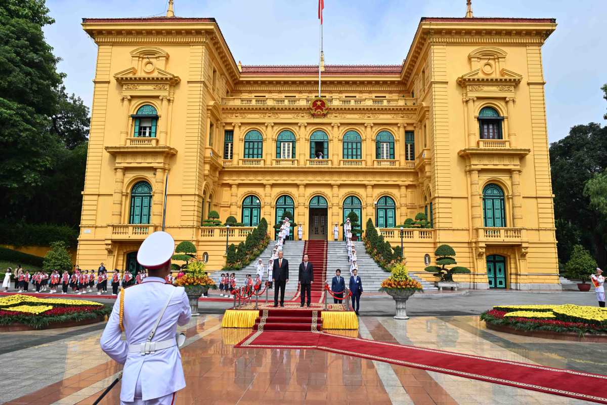 Hanoi Presidential Palace Front Garden with Children Children in uniform lined up in the gardens of the Hanoi Presidential Palace, surrounded by greenery