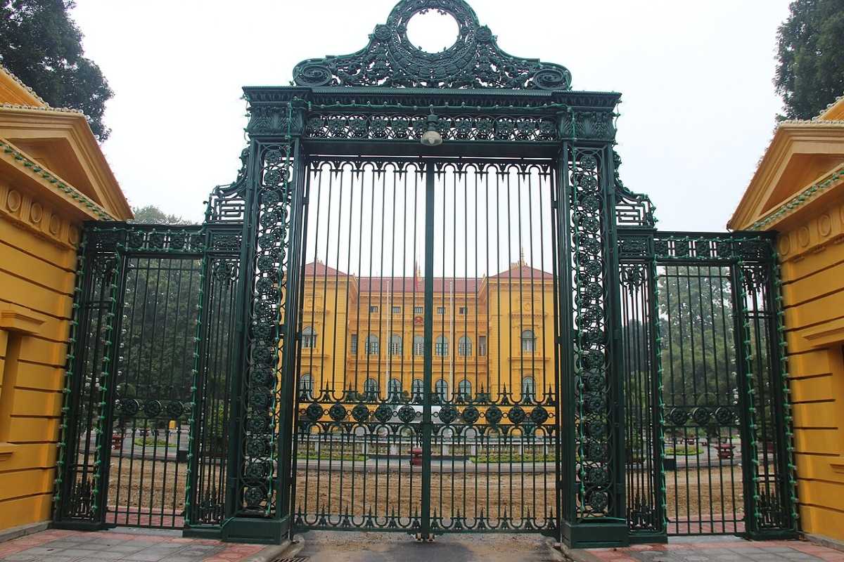 Hanoi Presidential Palace Front Gates Ornate green iron gates at the entrance of the Hanoi Presidential Palace with yellow walls