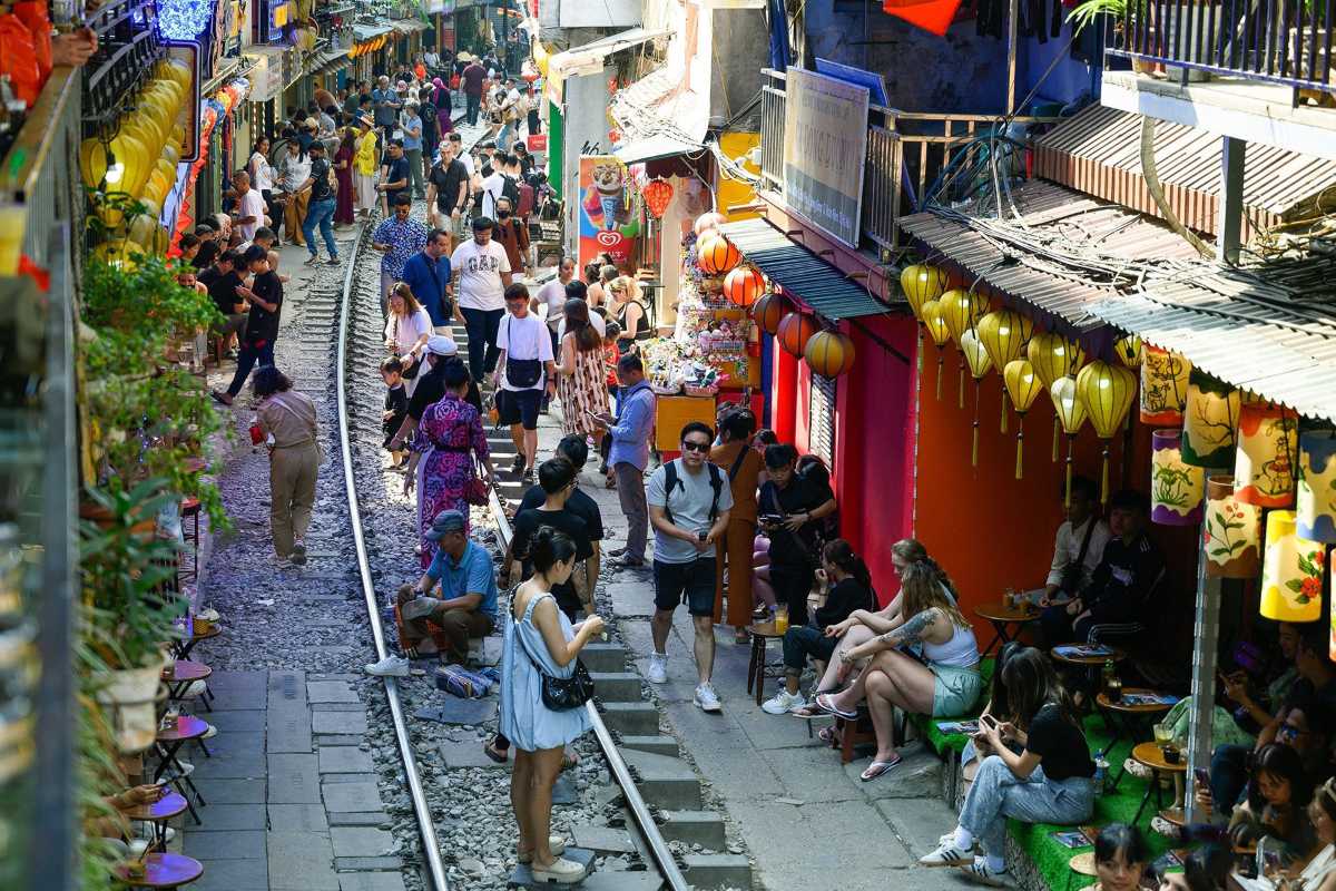 Crowded Daytime Scene on Hanoi Train Street Daytime crowd gathered along Hanoi Train Street railway tracks