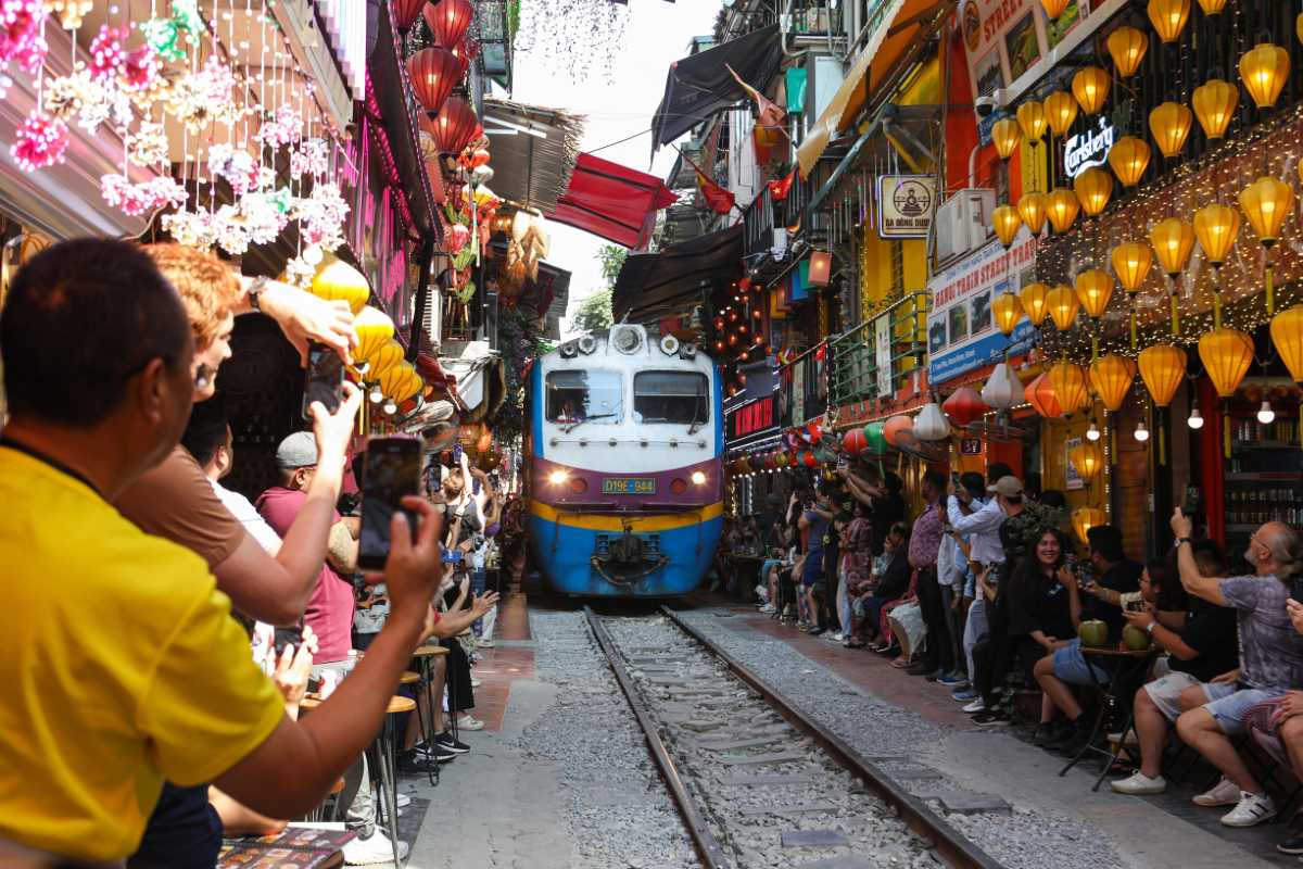 Crowd Watching Train Pass by Hanoi Train Street Crowds watching a train passing through Hanoi Train Street’s narrow railway corridor