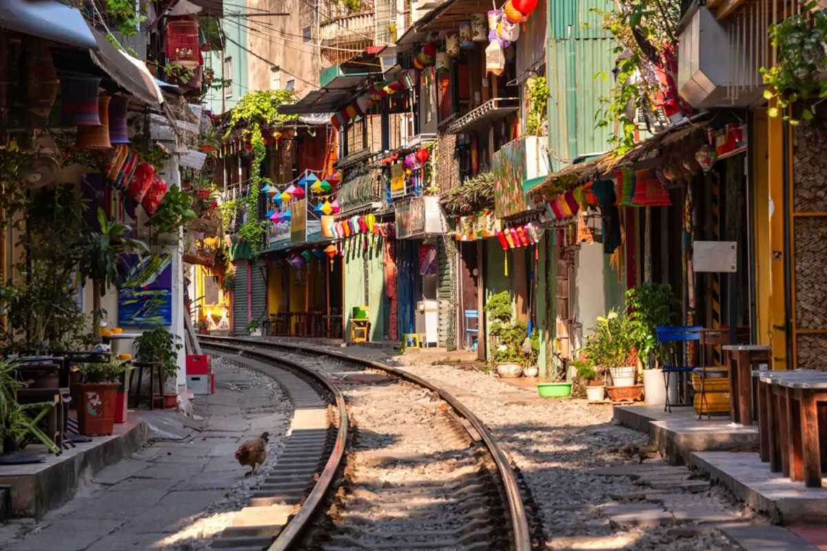 Colorful Hanoi Train Street with Evening Activity Evening scene of Hanoi Train Street with colorful lanterns and people enjoying the area