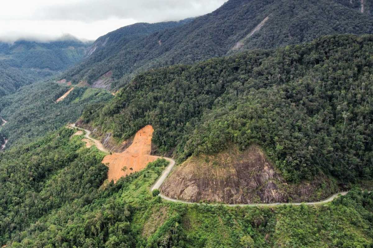 Landslide area on Heaven Pass road Eroded red slope beside Heaven Pass highway showcasing landslide-prone terrain.