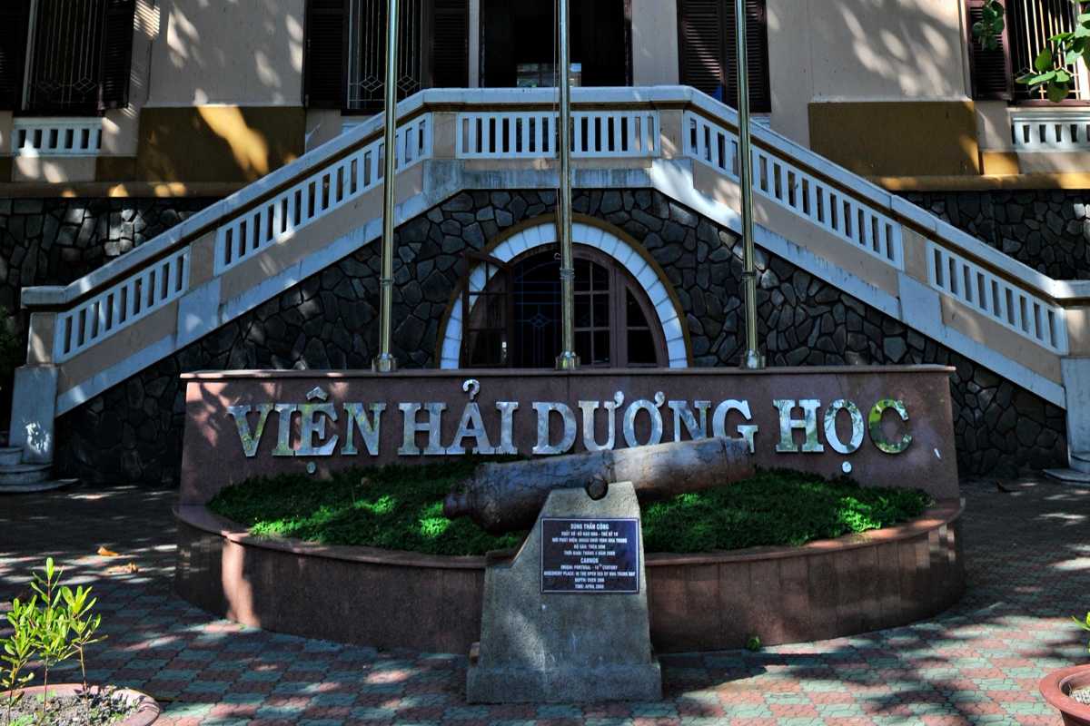 Historic cannon in front of museum entrance Old naval cannon displayed in front of the steps at the Institute of Oceanography in Nha Trang