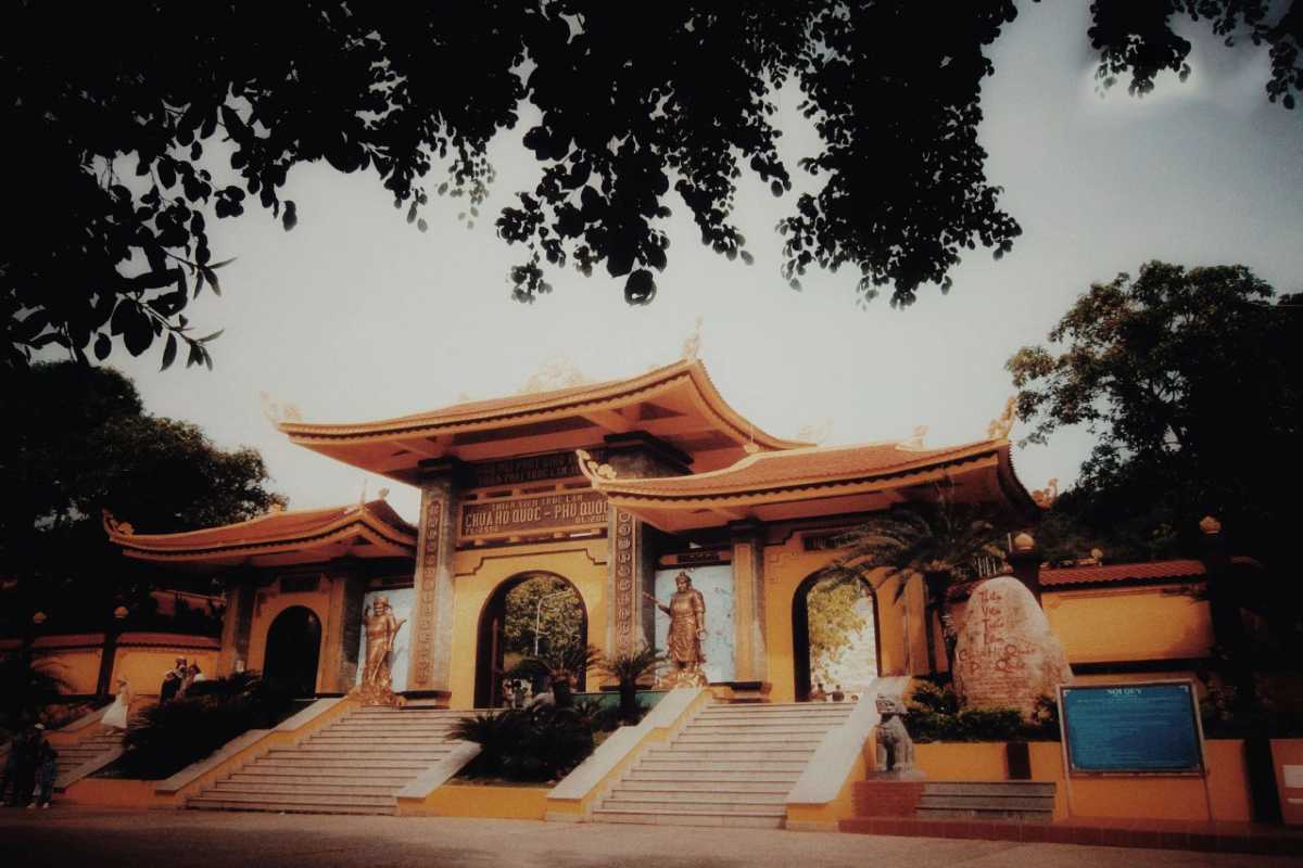 Front gate of Ho Quoc Pagoda on Phu Quoc Island showing traditional Vietnamese architecture and statues