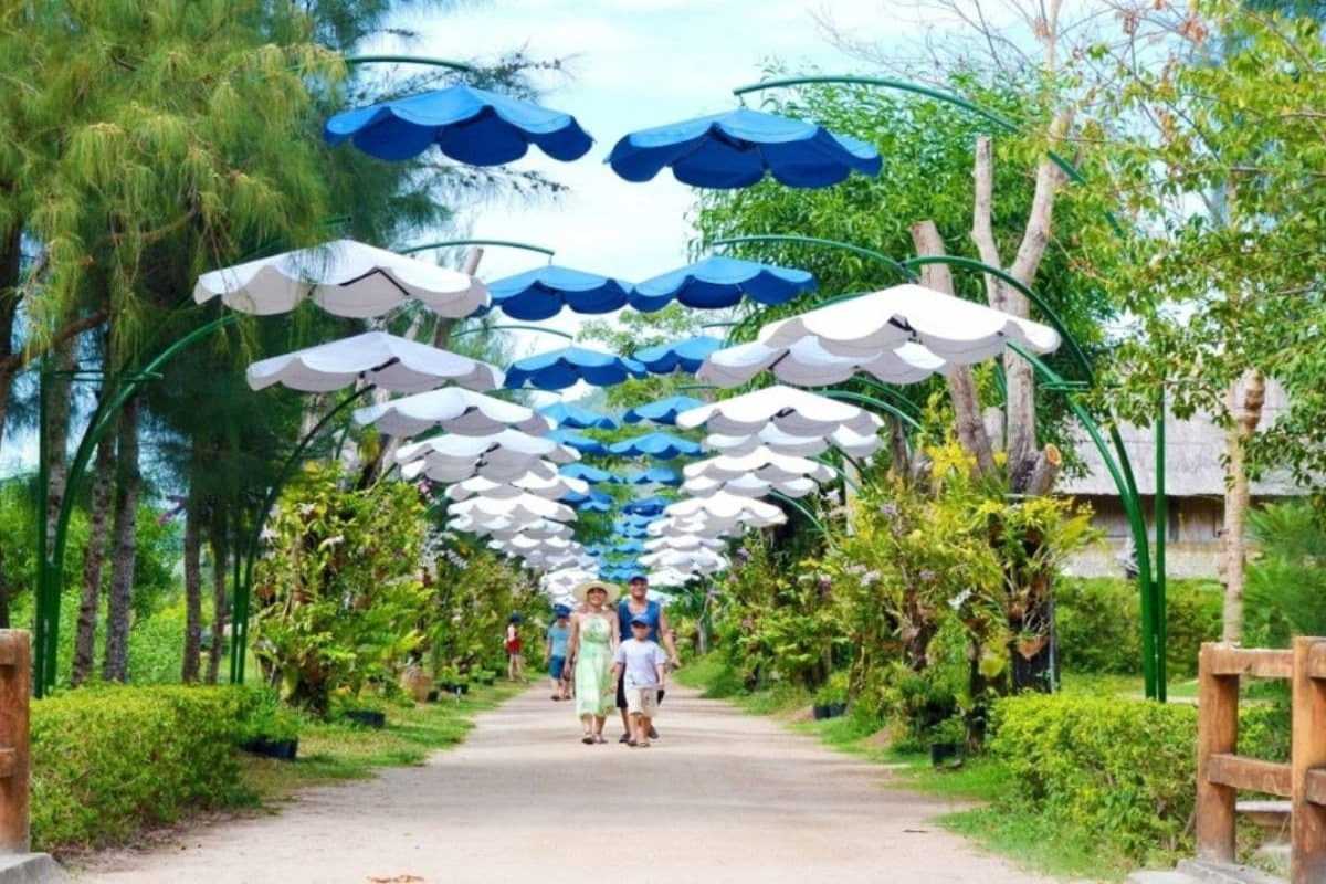 Floral Canopy Walkway at Hoa Lan Stream Orchid Island Nha Trang Floral canopy walkway with blue and white umbrellas creating a colorful path at Hoa Lan Stream Orchid Island Nha Trang.