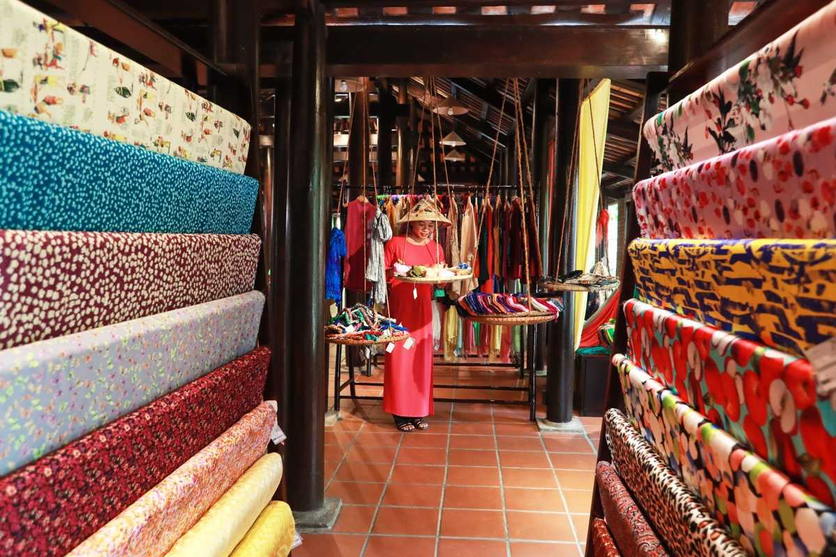 Colorful Silk Rolls and Display at Hoi An Silk Village Rolls of bright, patterned silk fabric stacked in a shop interior at Hoi An Silk Village