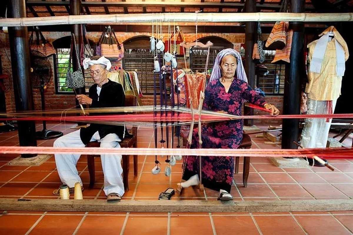 Traditional Loom Weaving at Hoi An Silk Village Local artisans weaving silk fabric on traditional wooden looms inside Hoi An Silk Village