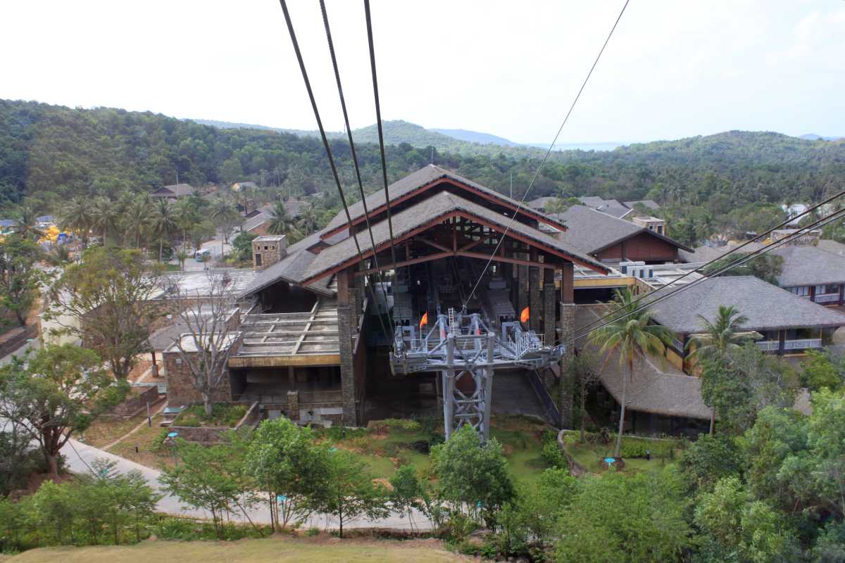 Hon Thom Cable Car Cabin Over Coastal Village Cable car cabin flying over coastal village near Hon Thom Cable Car Station