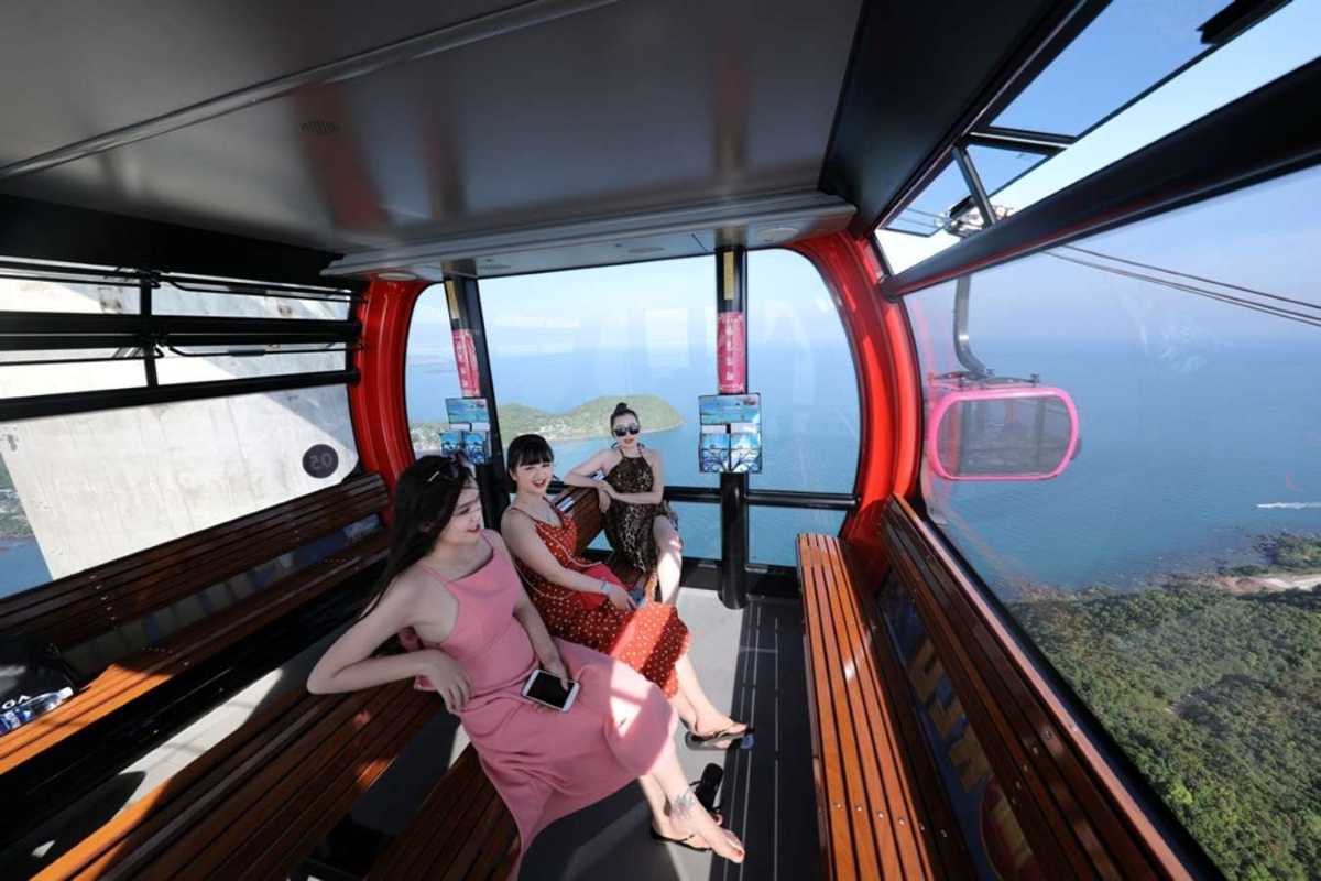 Orange Cable Car Cabin Over Forest at Hon Thom Station Orange cable car cabin flying over lush forest near Hon Thom Cable Car Station