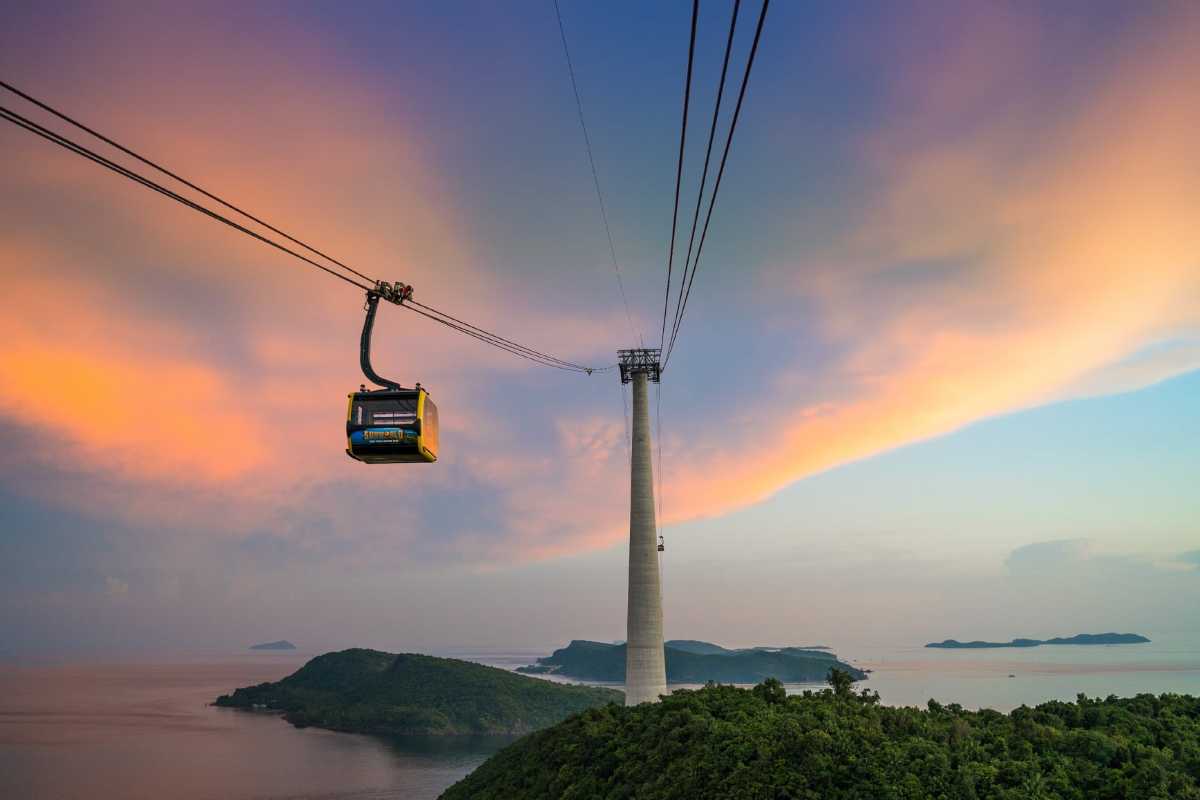 Cable Car Cabin Flying Above Forest and Waterpark Cable car cabin flying over forest and waterpark near Hon Thom Cable Car Station