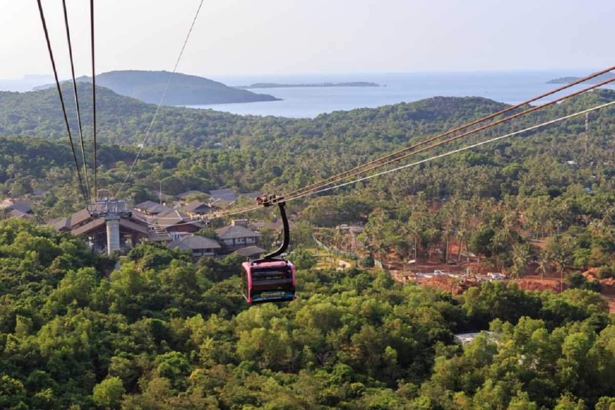 Hon Thom Cable Car Station with Palm Trees View Hon Thom Cable Car Station cabin floating above palm trees and blue sea at Phu Quoc Island