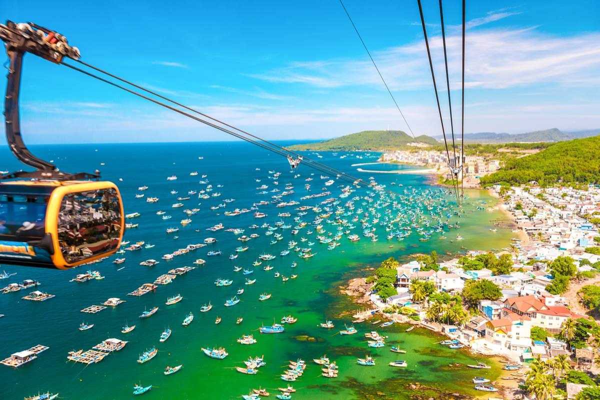 Hon Thom Cable Car Station with Sunworld Cabins Cable cars branded Sunworld at Hon Thom Cable Car Station over blue waters near Phu Quoc Island