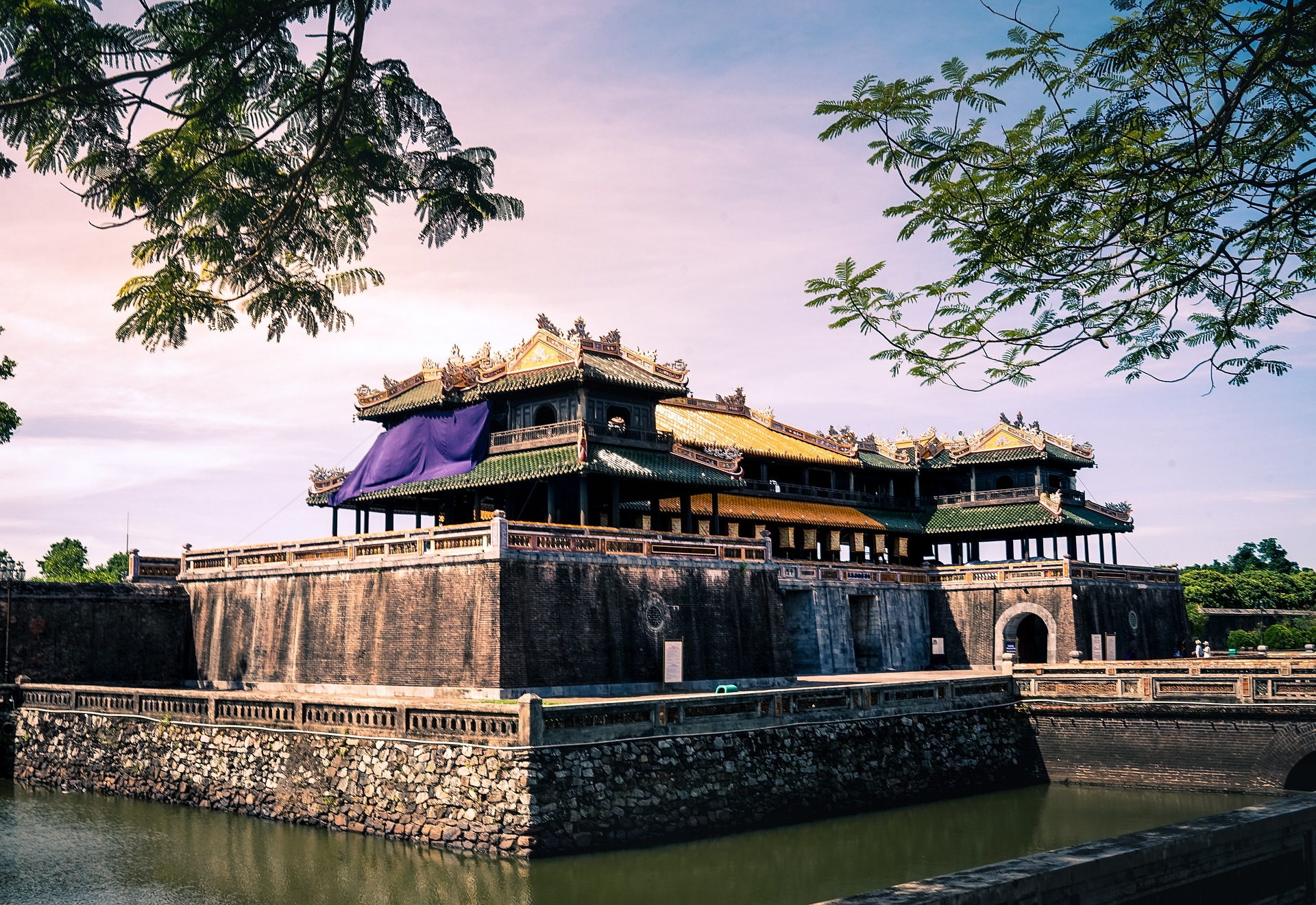 A breathtaking view of the Hue Imperial Citadel at sunset, highlighting its ancient architecture and historical significance.