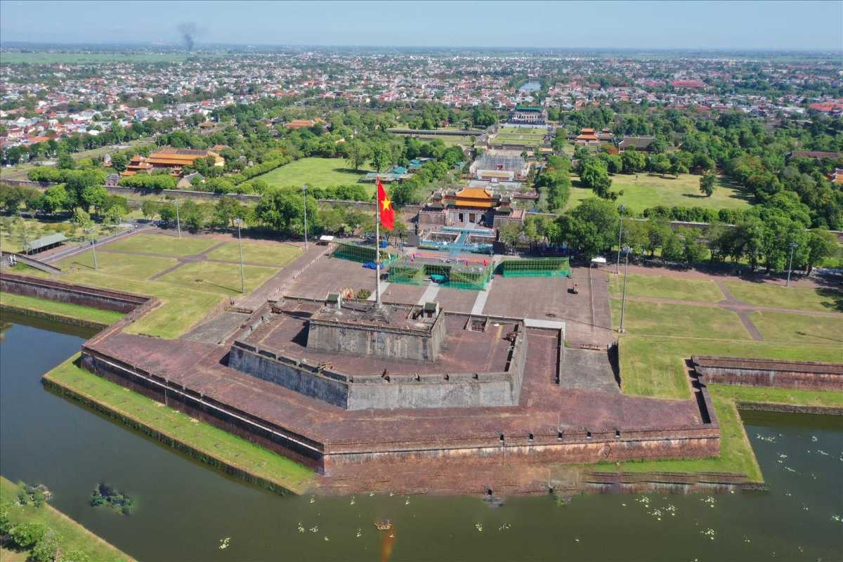 Central Flag Tower and citadel moat of Hue Imperial City The central Flag Tower and star-shaped moat of Hue Imperial City, surrounded by historic walls, ancient gates, and city greenery.