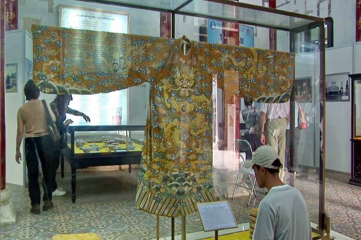 Imperial robe of Nguyen Dynasty at Hue Museum of Royal Antiquities Detailed imperial robe with golden dragon motifs from Nguyen Dynasty, displayed at Hue Museum of Royal Antiquities