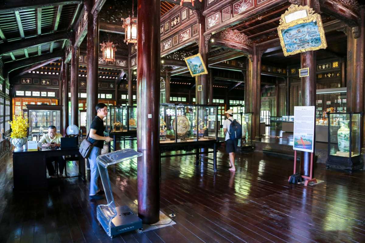 Hue Museum of Royal Antiquities main hall with royal displays Main hall of Hue Museum of Royal Antiquities with Nguyen Dynasty treasures, showcases, and ornate wooden architecture
