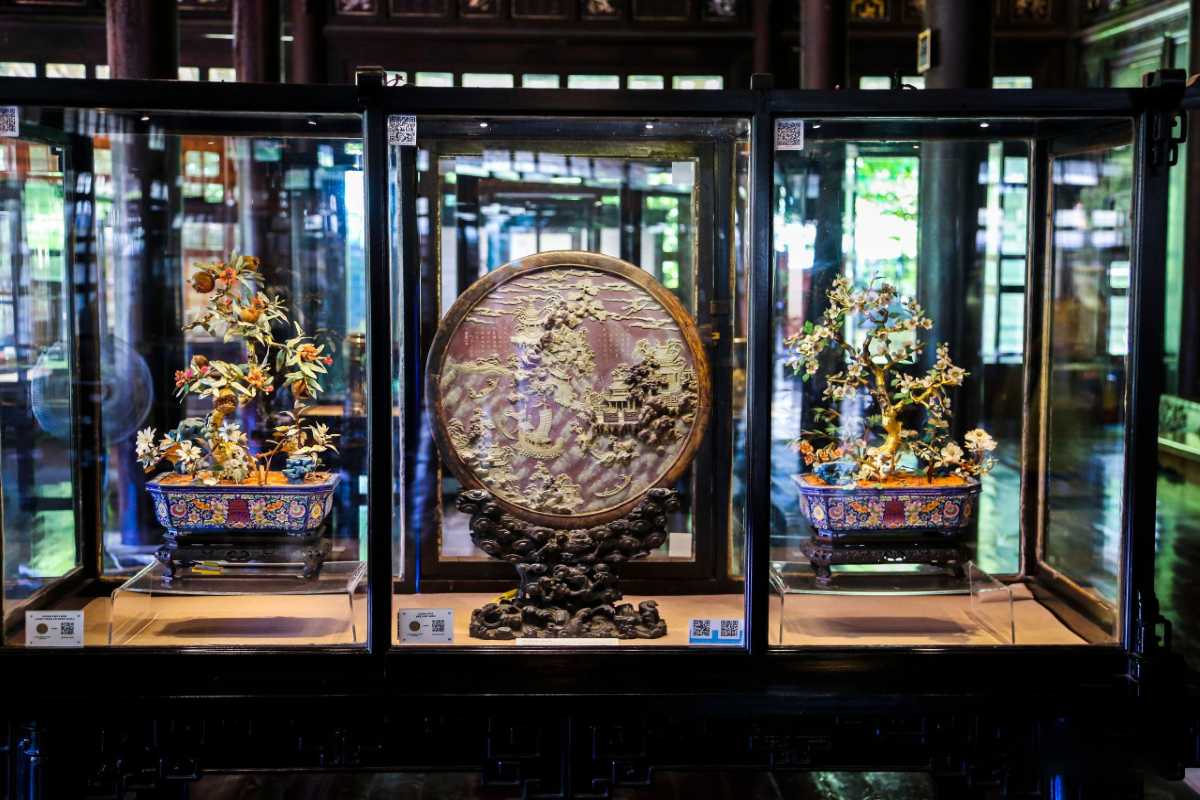 Exquisite artifacts at Hue Museum of Royal Antiquities Glass cases with Nguyen Dynasty treasures and decorative artwork at Hue Museum of Royal Antiquities in Hue, Vietnam