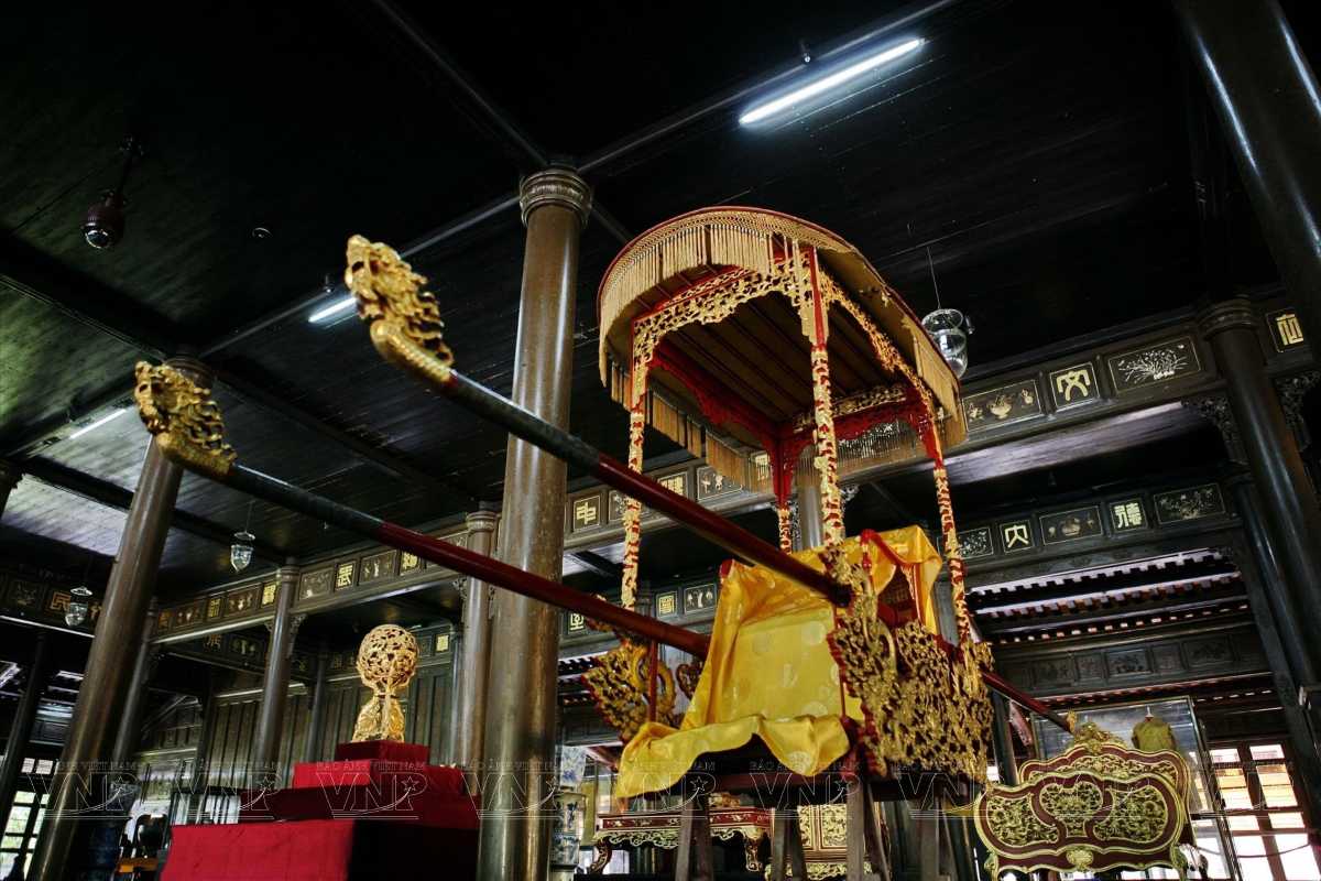 Royal palanquin on display at Hue Museum of Royal Antiquities Ornate Nguyen Dynasty royal palanquin with golden dragon details displayed at Hue Museum of Royal Antiquities