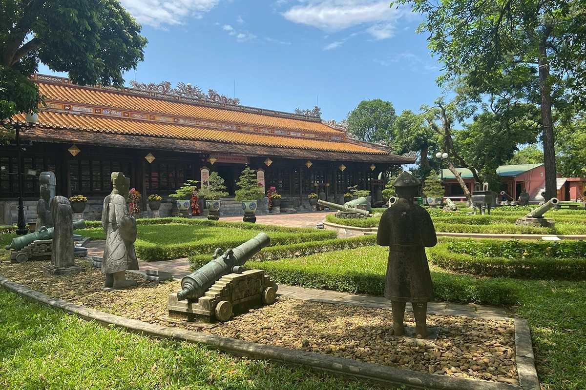 Outdoor statues and cannons at Hue Museum of Royal Antiquities Stone statues and historic cannons in the outdoor gardens at Hue Museum of Royal Antiquities, blending art and history