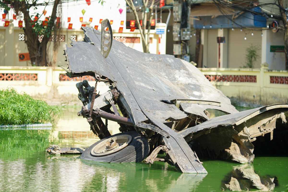Huu Tiep B-52 Lake Hanoi War Memorial and Wreckage B-52 bomber wreckage next to the war memorial in Huu Tiep Lake Hanoi reflecting on the water surface