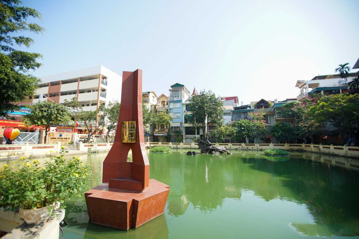 Huu Tiep Lake Hanoi with B-52 Wreckage and Memorial Panoramic view of Huu Tiep Lake Hanoi with B-52 wreckage and war memorial surrounded by urban buildings