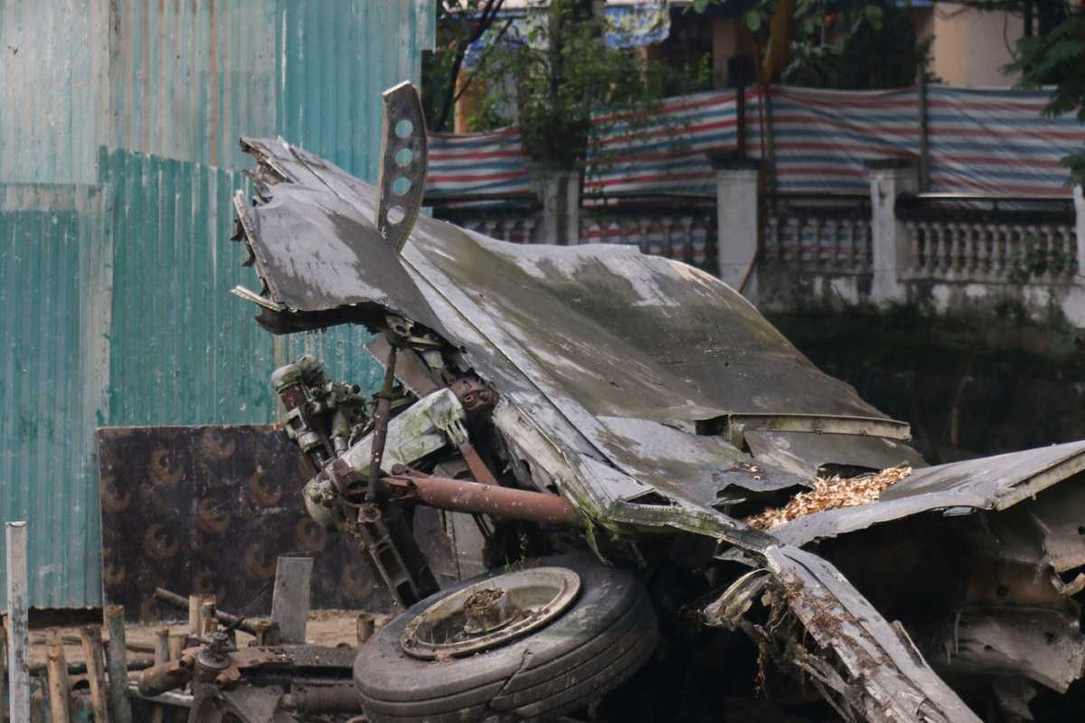 Huu Tiep Lake Hanoi with Warplane Wreckage Warplane wreckage submerged in the green waters of Huu Tiep Lake Hanoi with urban surroundings