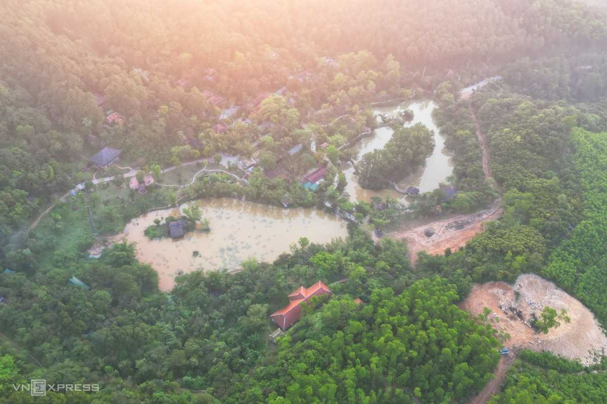 Huyen Khong Son Thuong Pagoda Hue aerial view of Zen lakes and forest retreat Huyen Khong Son Thuong Pagoda Hue seen from above with Zen lakes, dense forest, and mountain retreat at sunrise