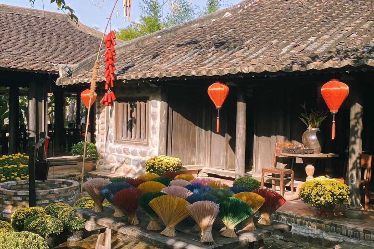 Incense Sticks in Traditional Courtyard Colorful incense bundles set out to dry in a village courtyard decorated with lanterns near the Cai River in Nha Trang.