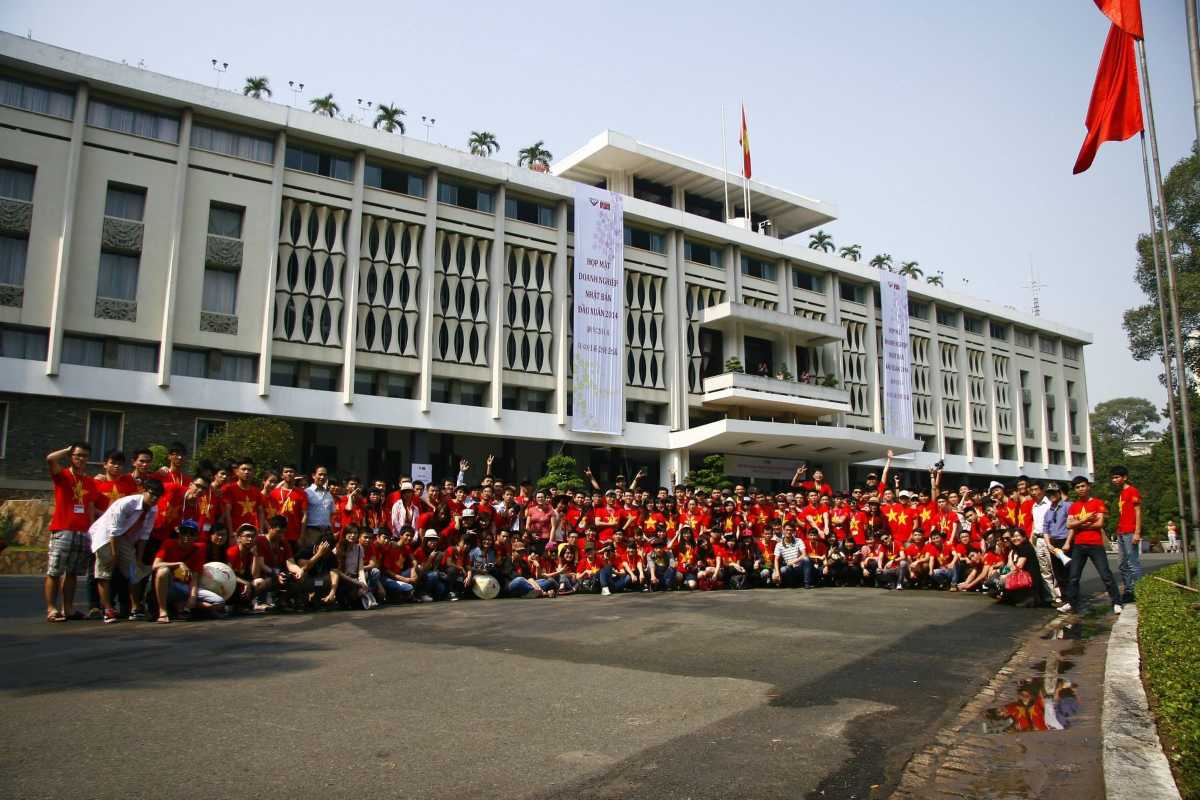 Group Visit at Independence Palace Saigon Entrance Large group of visitors wearing red shirts outside the main entrance of Independence Palace Saigon