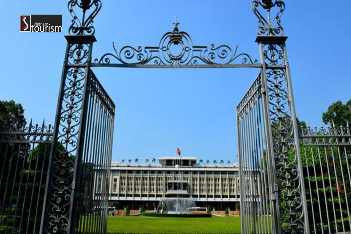 Iron Gate and Facade of Independence Palace Saigon Ornate iron gate opening to the facade of Independence Palace Saigon with flags flying