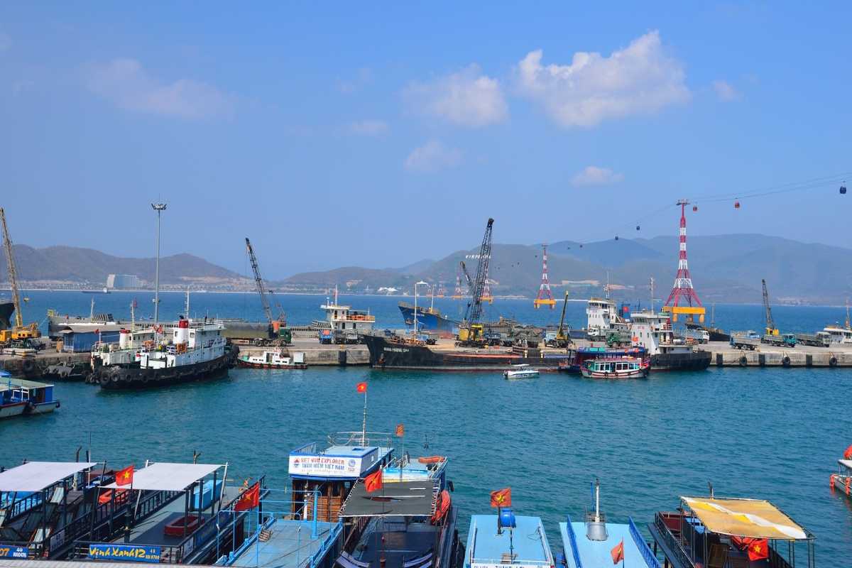 Industrial and tourism vessels at Cau Da Port Cranes and boats at Cau Da Port Nha Trang showing both cargo and tourism use.