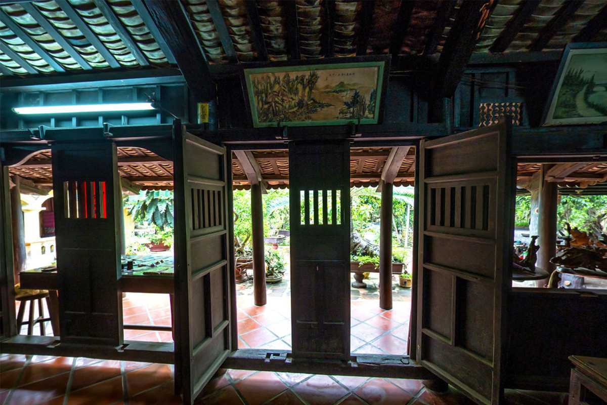 Interior view of traditional wooden house View from inside a wooden house at Phu Vinh Ancient Village looking toward a garden courtyard
