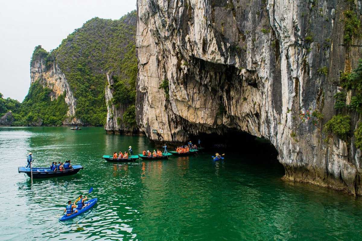 Kayaking Luon Cave Halong Bay twin paddlers Two paddlers kayaking through Luon Cave Halong Bay wearing life jackets and enjoying the experience