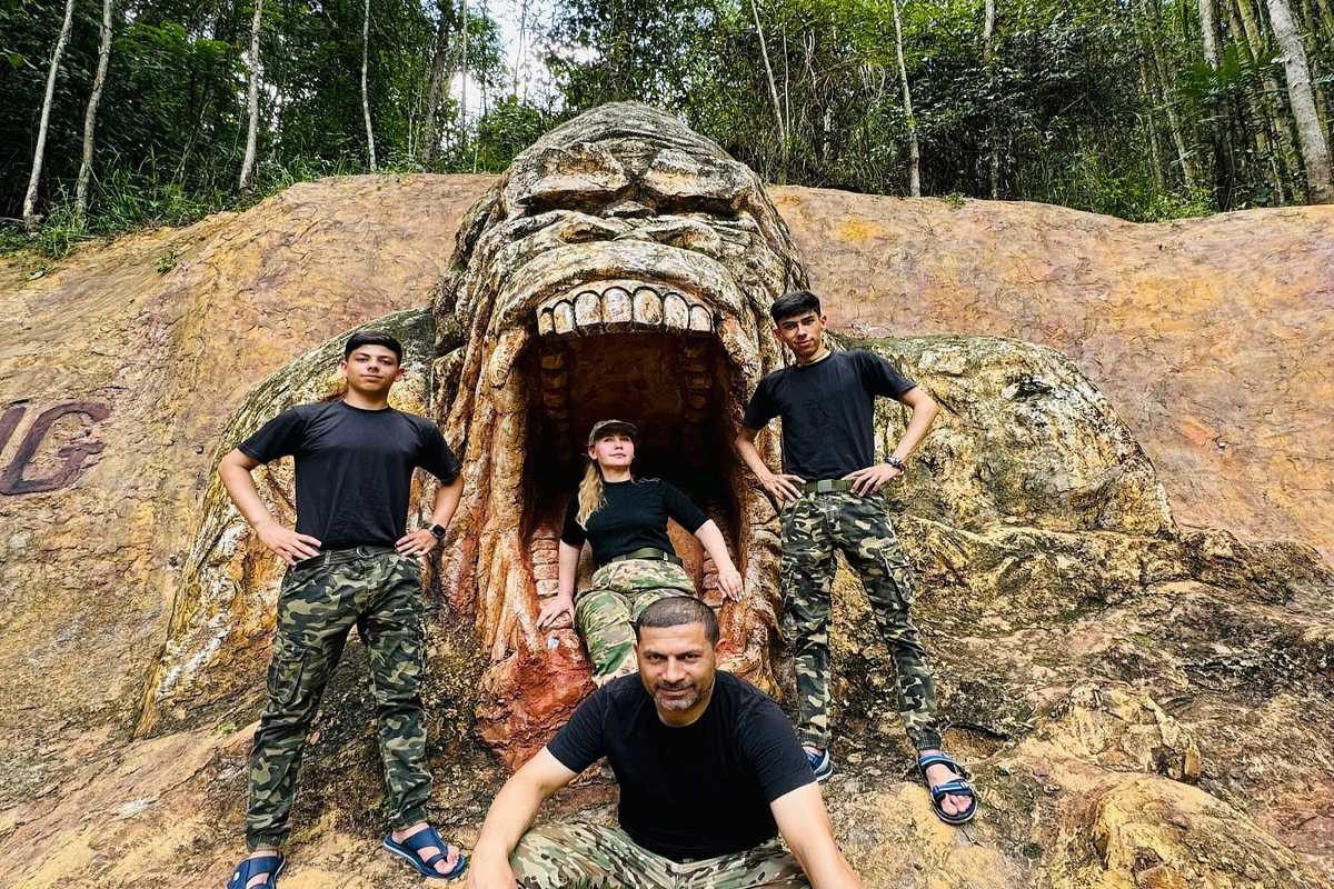 Kong Forest Group Photo at Entrance Sculpture Group of tourists posing in front of Kong Forest entrance rock sculpture at Hon Ba Nature Reserve